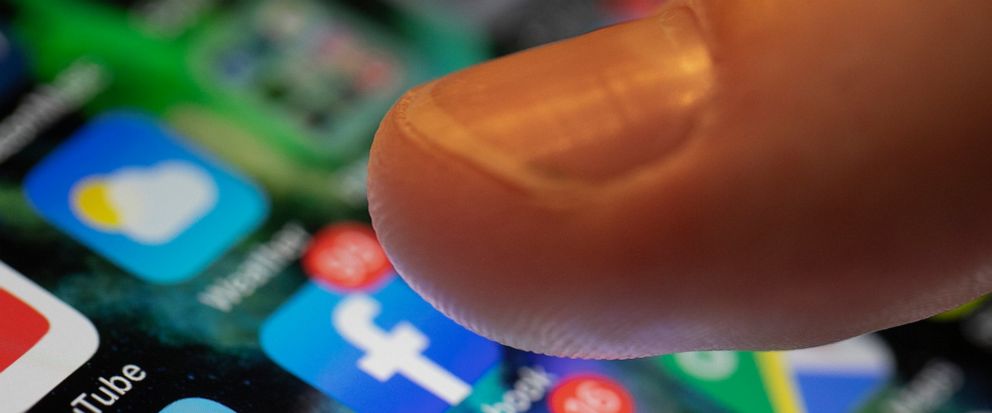 In this Sunday, Aug. 11, 2019, photo an iPhone displays the apps for Facebook and Messenger in New Orleans. Facebook says it paid contractors to transcribe audio clips from users of its Messenger service. (AP Photo/Jenny Kane)