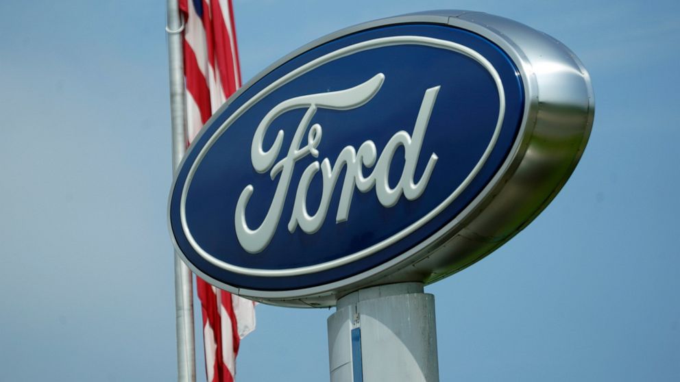 FILE - A Ford logo is seen on signage at Country Ford in Graham, N.C., Tuesday, July 27, 2021. Ford and Purdue University are working to create a new charging station cable that could combine with in-development vehicle charging technology, making it