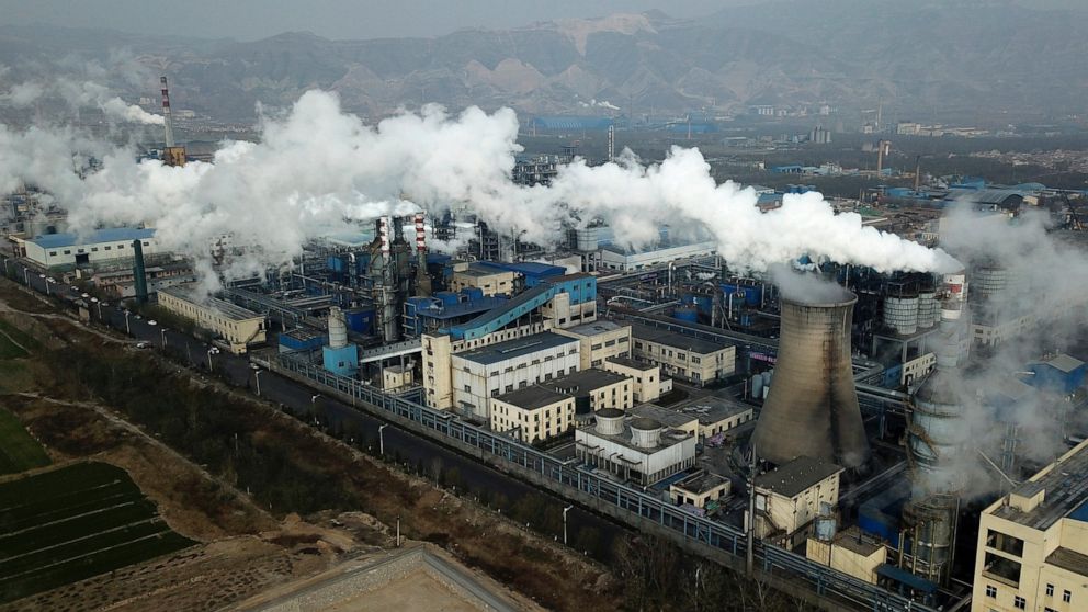 FILE - Smoke and steam rise from a coal processing plant in Hejin in central China's Shanxi Province on Nov. 28, 2019. China has cut off climate talks with the U.S. — imperiling future global climate negotiations, but not necessarily blunting the imp