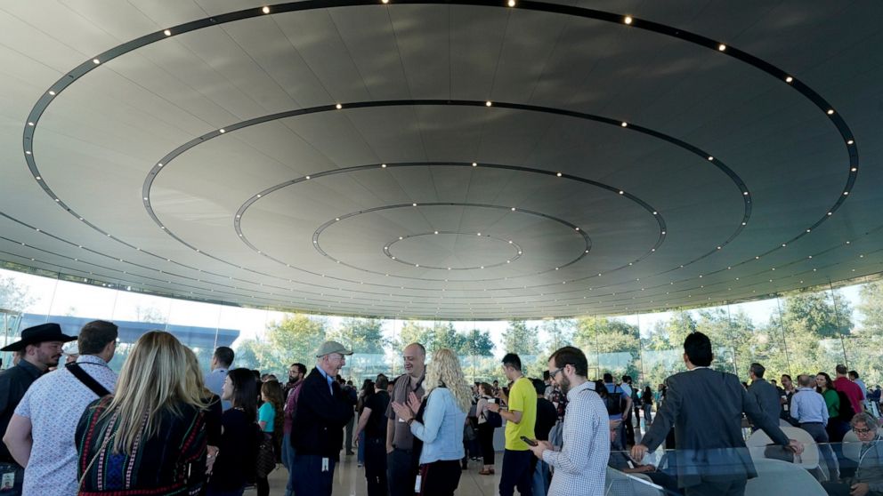 People arrive at Apple for an event to announce new products Tuesday, Sept. 10, 2019, in Cupertino, Calif. (AP Photo/Tony Avelar)