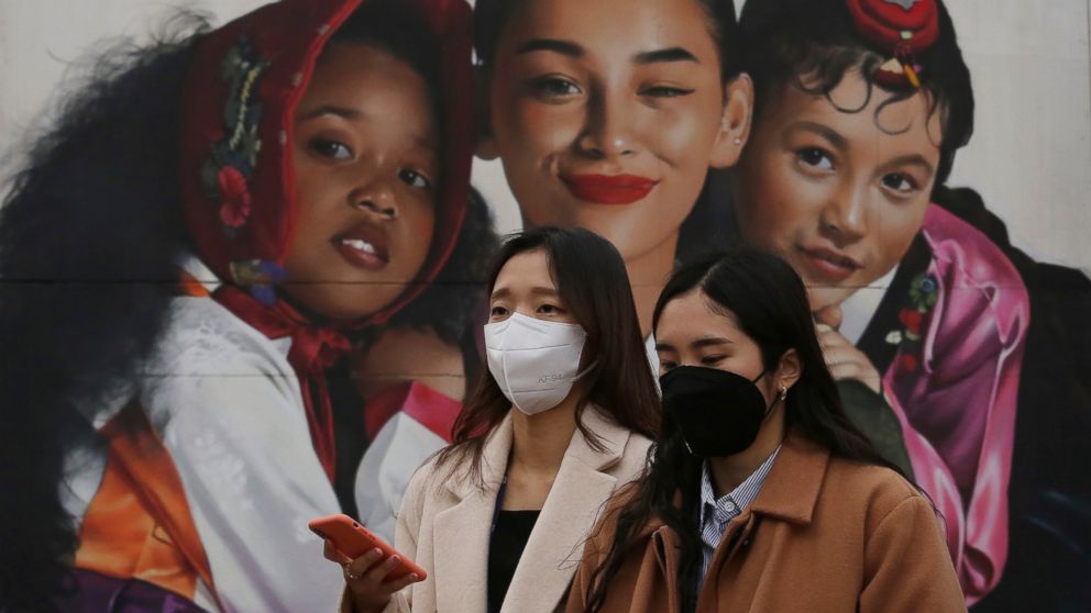 Women wearing masks to protect from air pollution walk in Seoul, South Korea, Wednesday, March 6, 2019. South Korean President Moon Jae-in has proposed a joint project with China to use artificial rain to clean the air in Seoul, where an acute increa