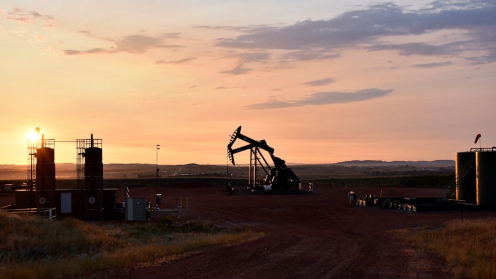 FILE - An oil well works at sunrise Aug. 25, 2021, in Watford City, N.D., part of McKenzie County. U.N. Secretary-Antonio Guterres warned Tuesday, June 14, of a “dangerous disconnect” between what scientists and citizens are demanding to curb climate