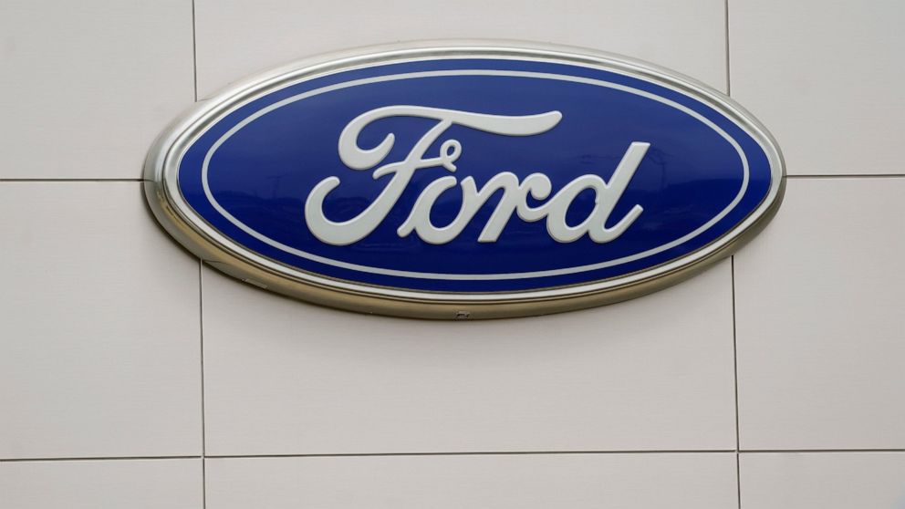 A Ford logo is seen on signage at Country Ford in Graham, N.C., Tuesday, July 27, 2021. Ford Motor Co. has hired a former executive from Apple and Tesla to be the company's head of advanced technology and new embedded systems, a critical post as the 