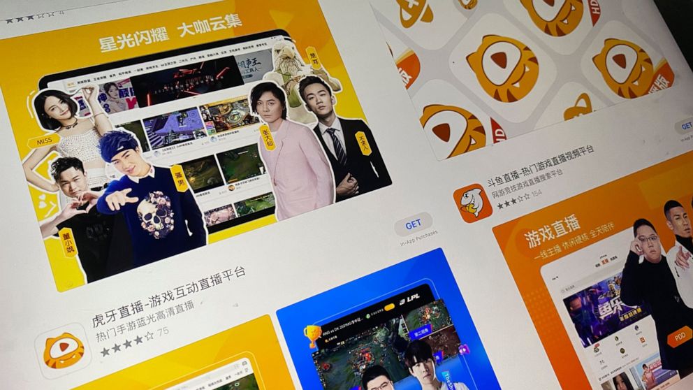 An app store page showing the apps Huya and Douyu is seen on a screen in Beijing on Saturday, July 10, 2021. China's market regulator on Saturday blocked the merger of Tencent-backed game streaming platforms Douyu and Huya following an anti-monopoly 