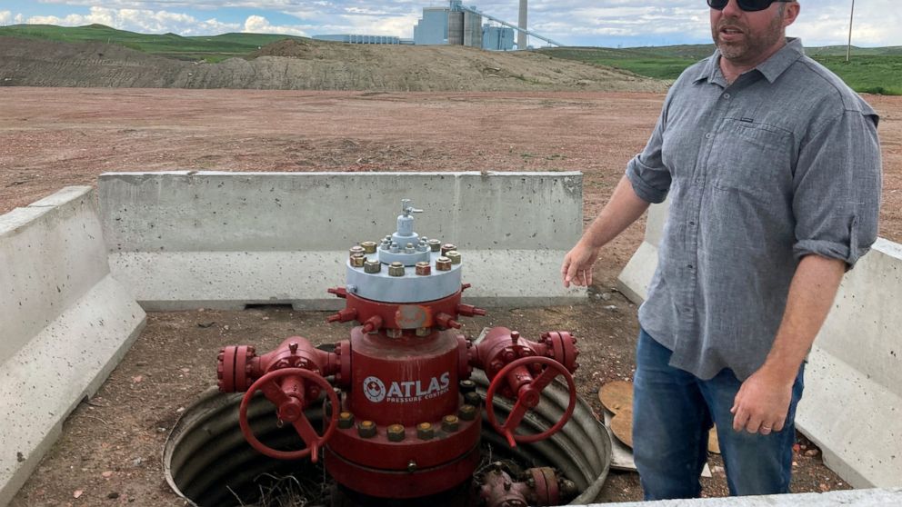 Fred McLaughlin, director of the Center for Economic Geology Research at the University of Wyoming, stands near one of two wells drilled near the Dry Fork Station coal-fired power plant outside Gillette, Wyo., on June 14, 2022. McLaughlin and other r