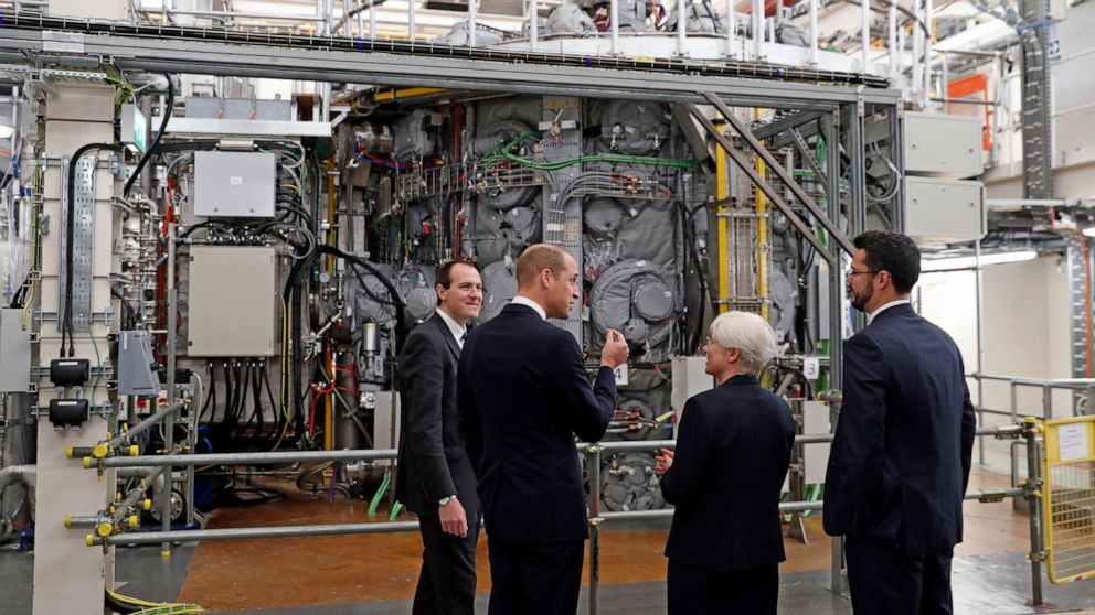 FILE - Britain's Prince William, Duke of Cambridge, 2nd left, talks with Professor Ian Chapman, CEO of the UK Atomic Energy Authority, left, Nanna Heiberg, 2nd right, and Joseph Milnes, head of engineering design unit, right, alongside the MAST Upgra