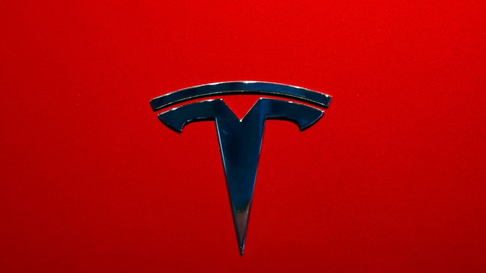 FILE- The logo of Tesla model 3 is seen at the Auto show on Oct. 3, 2018, in Paris. Tesla delivered its first electric semis to PepsiCo Thursday, Dec. 1, 2022, more than three years after Elon Musk said the company would start making the trucks. (AP 
