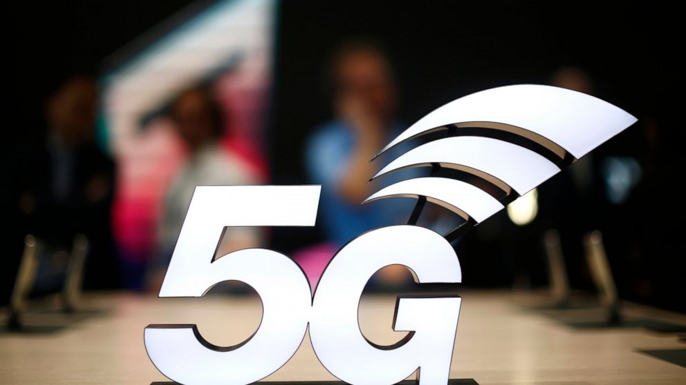 FILE - This Feb. 25, 2019 file photo shows a banner of the 5G network is displayed during the Mobile World Congress wireless show, in Barcelona, Spain. The U.S. communications regulator will hold a massive auction to bolster 5G service, the next generation of mobile networks, and will spend $20 billion for rural internet. 5G will mean faster wireless speeds and has implications for technologies like self-driving cars and augmented reality. The Federal Communications Commission said Friday, April 12, that it would hold the largest auction in U.S. history, of 3,400 megahertz, to boost wireless companies’ networks. (AP Photo/Manu Fernandez, File)
