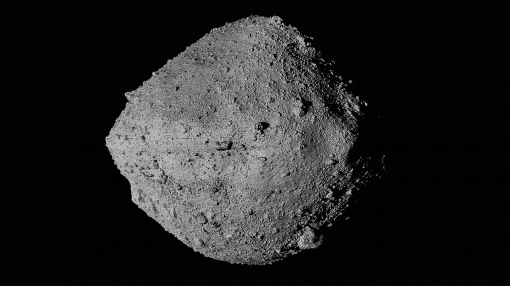 This undated image made available by NASA shows the asteroid Bennu from the OSIRIS-REx spacecraft. After almost two years circling the ancient asteroid, OSIRIS-REx will attempt to descend to the treacherous, boulder-packed surface and snatch a handfu
