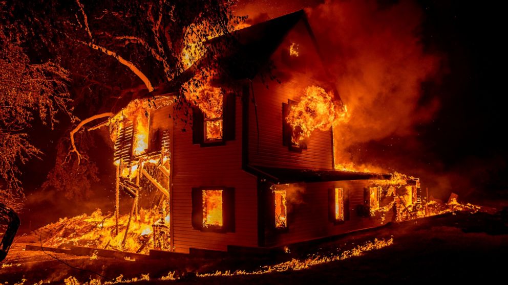 FILE - A home is engulfed in flames as the Dixie fire rages south of Janesville in Northern California, on Aug. 16, 2021. (AP Photo/Ethan Swope, File)