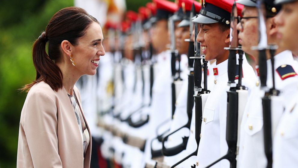 New Zealand's Prime Minister Jacinda Ardern speaks with a member of the honor guard during a welcome ceremony at the Istana or presidential palace in Singapore, Friday, May 17, 2019. (AP Photo/Yong Teck Lim)