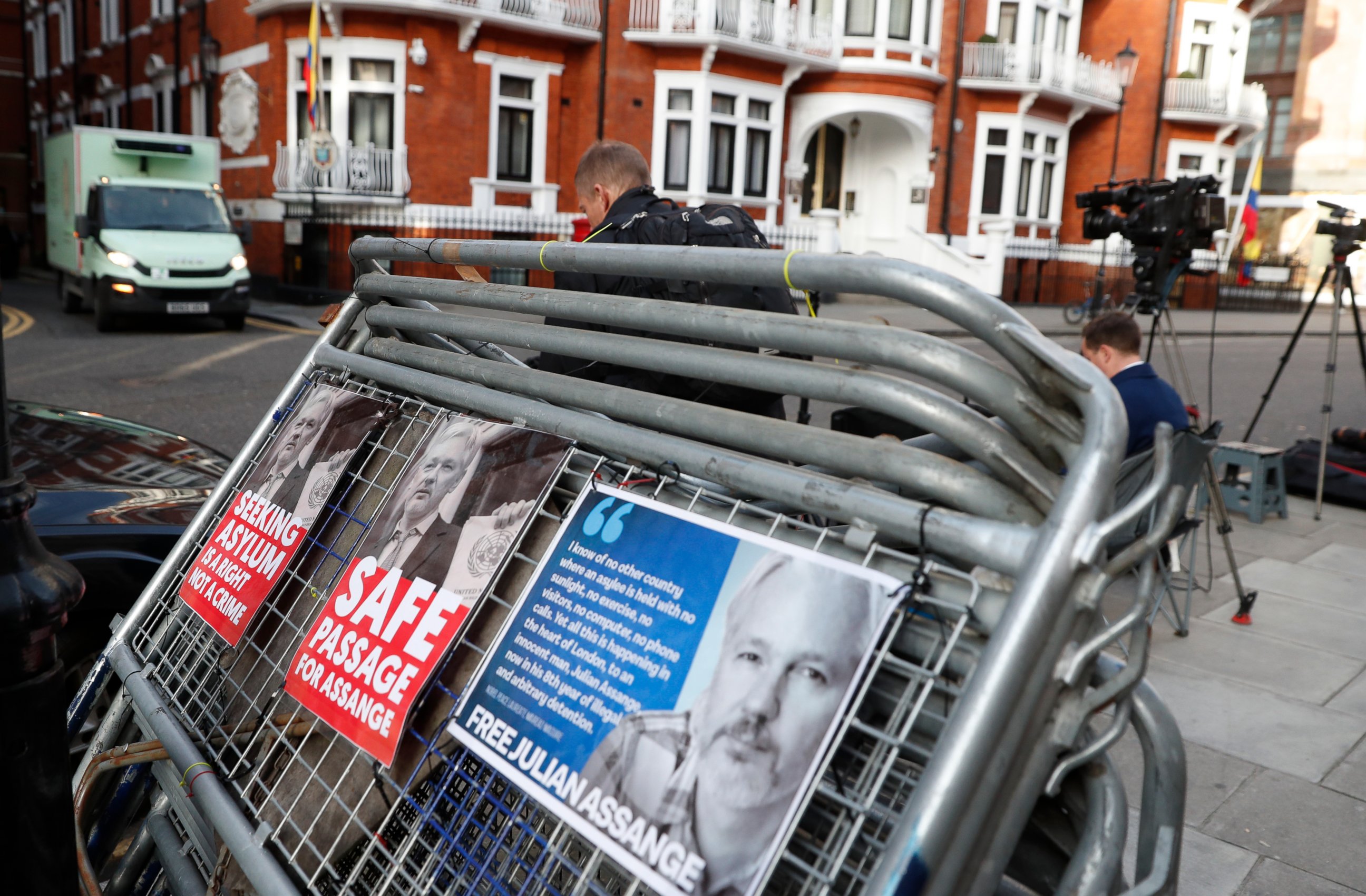 Placards on a crowd barriers outside the Ecuadorian Embassy in London, Friday, April 5, 2019, where Wikileaks founder Julian Assange has been holed up since 2012. A senior Ecuadorian official said no decision has been made to expel Julian Assange fro