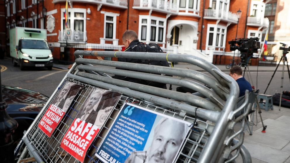 Placards on a crowd barriers outside the Ecuadorian Embassy in London, Friday, April 5, 2019, where Wikileaks founder Julian Assange has been holed up since 2012. A senior Ecuadorian official said no decision has been made to expel Julian Assange fro