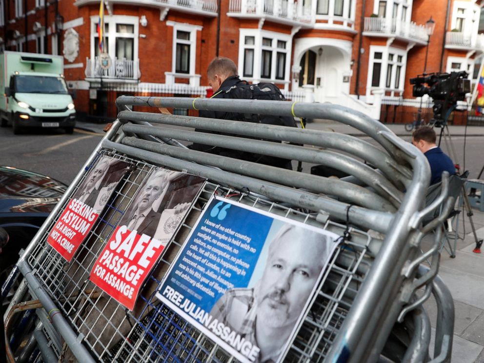 Placards on a crowd barriers outside the Ecuadorian Embassy in London, Friday, April 5, 2019, where Wikileaks founder Julian Assange has been holed up since 2012. A senior Ecuadorian official said no decision has been made to expel Julian Assange fro