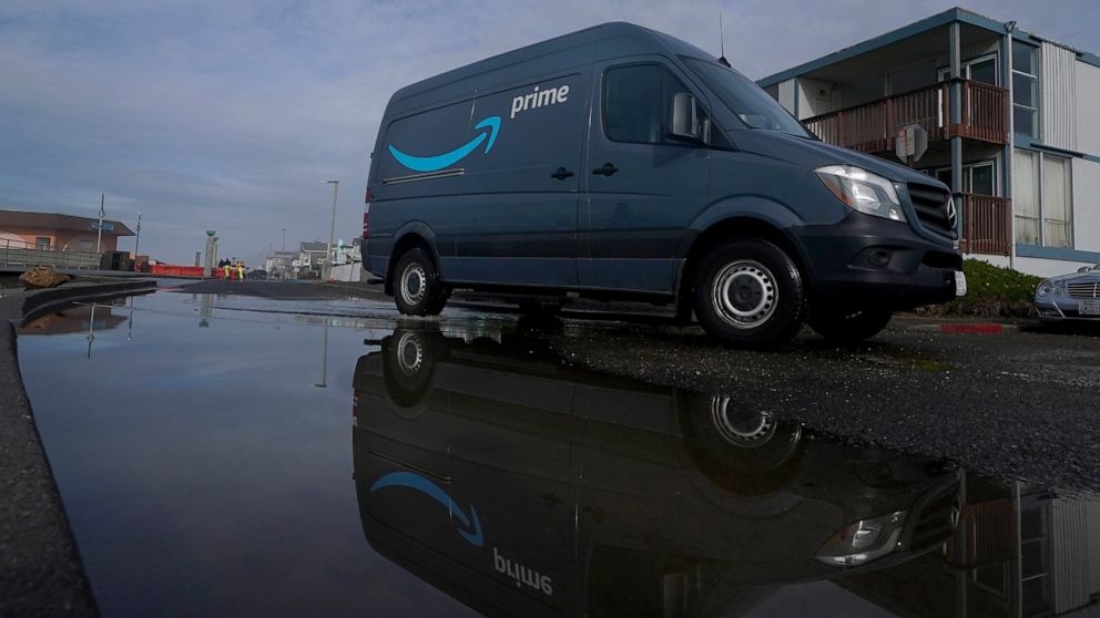 FILE - An Amazon Prime truck drives in Pacifica, Calif., on Dec. 15, 2020. Amazon has begun mass layoffs in its corporate ranks, becoming the latest tech company to trim its workforce amid rising fears about the wider economic environment. (AP Photo/
