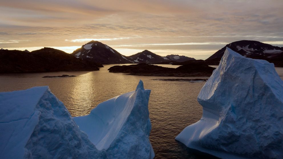 FILE - This early Friday, Aug. 16, 2019 file photo shows an aerial view of large Icebergs floating as the sun rises near Kulusuk, Greenland. Greenland has been melting faster in the last decade, and this summer, it has seen two of the biggest melts o