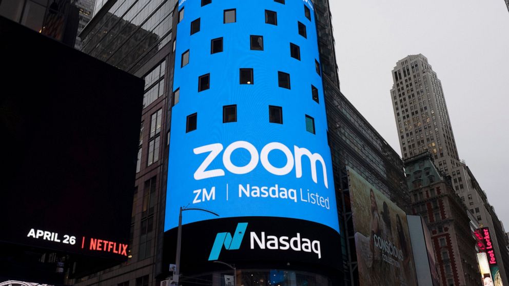 FILE - This April 18, 2019, file photo shows a sign for Zoom Video Communications ahead Nasdaq IPO in New York. Video app company Zoom said Thursday, June 11 2020, it regretted that some meetings involving U.S.-based Chinese dissidents were disrupted