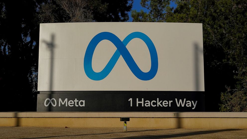 FILE - Meta's logo can be seen on a sign at the company's headquarters in Menlo Park, Calif., on Nov. 9, 2022. John Carmack cut his ties with Meta Platforms, a holding company created last year by Facebook founder Mark Zuckerberg, in a Friday, Dec. 1