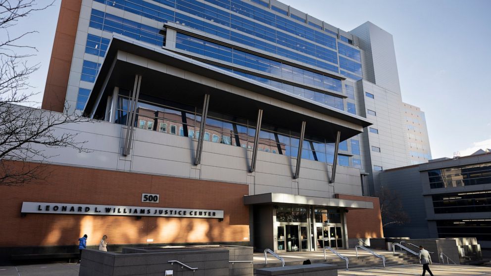 People walk by the Leonard L. Williams Justice Center in Wilmington, Del., Monday, Nov. 14, 2022. Testimony is under way in a shareholder lawsuit challenging approval by Tesla’s board of directors of a compensation plan potentially worth more than $5