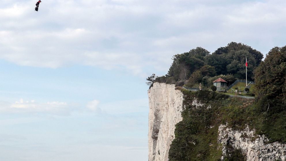 French inventor Franky Zapata lands near St. Margaret's beach, Dover after crossing the Channel on a flying board Sunday, Aug. 4, 2019. (Steve Parsons/PA via AP)