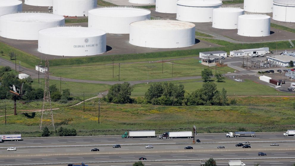 FILE - In this Sept. 8, 2008 file photo traffic on I-95 passes oil storage tanks owned by the Colonial Pipeline Company in Linden, N.J. A major pipeline that transports fuels along the East Coast says it had to stop operations because it was the vict