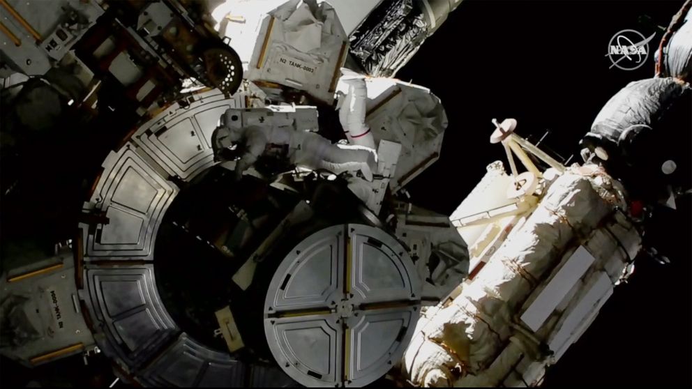 In this image provided by NASA shows NASA astronauts Victor Glover and Mike Hopkins on a spacewalk outside the International Space Station on Saturday, March 13, 2021. The astronauts are rearranging space station plumbing and tackling other odd jobs.