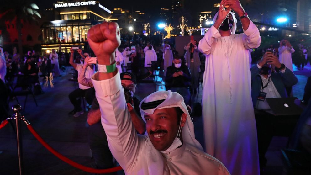 Emiratis celebrate after the Hope Probe enters Mars orbit as a part of Emirates Mars mission, in Dubai, United Arab Emirates, Tuesday, Feb. 9, 2021. The spacecraft from the United Arab Emirates swung into orbit around Mars in a triumph for the Arab w