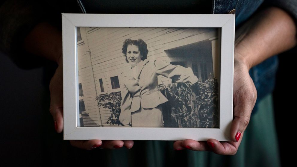 Stacy Cordova, whose aunt was a victim of California's forced sterilization program that began in 1909, holds a framed photo of her aunt Mary Franco, Monday, July 5, 2021, in Azusa, Calif. Franco was sterilized when she was 13 in 1934. Franco has sin