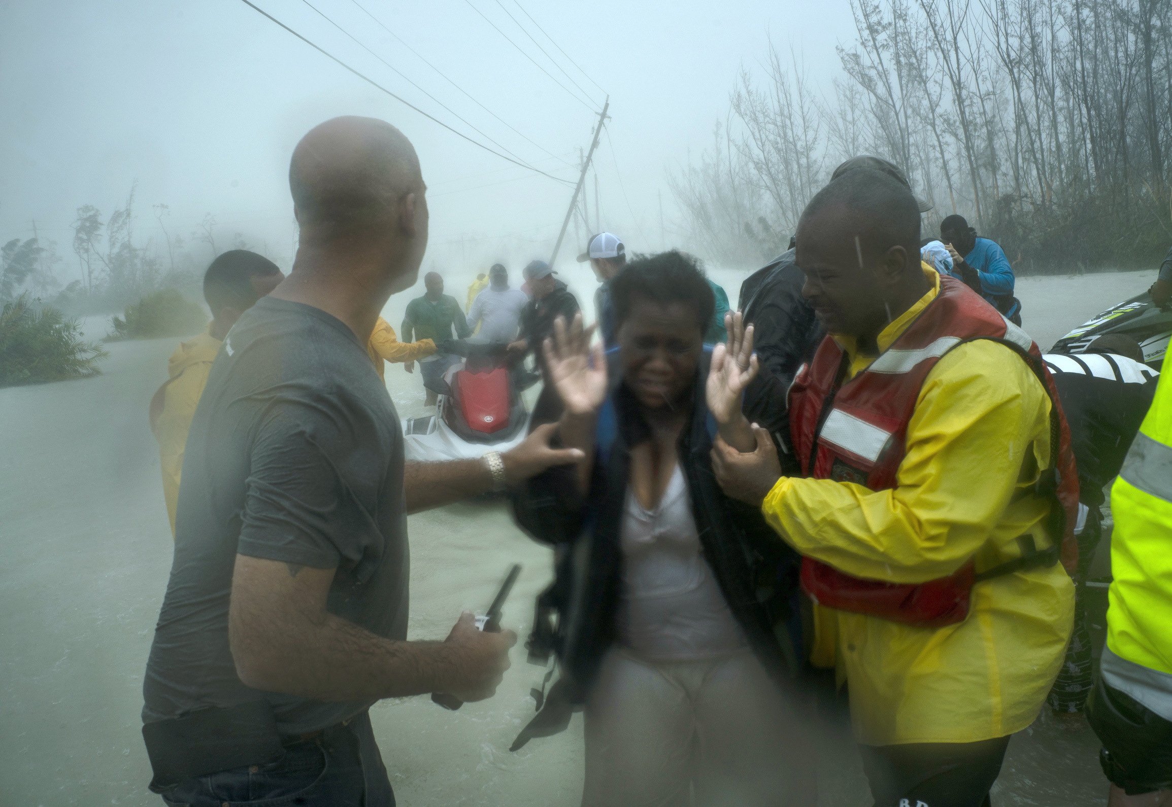 Volunteers rescue several families that arrived on small boats, from the rising waters of Hurricane Dorian, near the Causarina bridge in Freeport, Grand Bahama, Bahamas, Tuesday, Sept. 3, 2019. The storm’s punishing winds and muddy brown floodwaters 