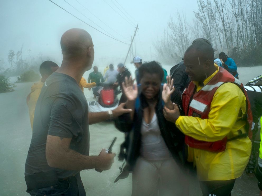 Volunteers rescue several families that arrived on small boats, from the rising waters of Hurricane Dorian, near the Causarina bridge in Freeport, Grand Bahama, Bahamas, Tuesday, Sept. 3, 2019. The storm’s punishing winds and muddy brown floodwaters 