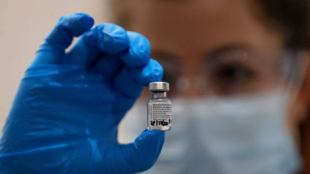 A nurse holds a phial of the Pfizer-BioNTech COVID-19 vaccine at Guy's Hospital in London, Tuesday, Dec. 8, 2020, as the U.K. health authorities rolled out a national mass vaccination program. U.K. regulators said Wednesday Dec. 9, 2020, that people 