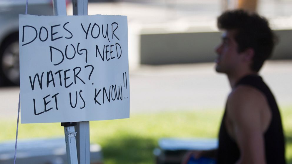 A sign that reads "Does your dog need water? Let us know!!" is seen Monday, June 28, 2021, at Yakima Community Aid's cooling station in Yakima, Wash. (Amanda Ray /Yakima Herald-Republic via AP)