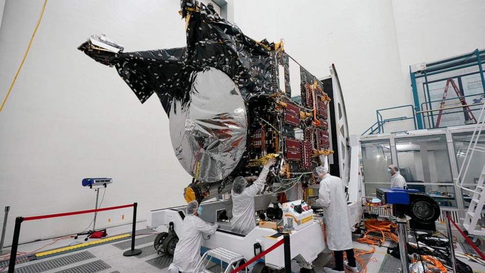 FILE - Technicians work on the Psyche spacecraft at the NASA Jet Propulsion Laboratory, April 11, 2022, in Pasadena, Calif. NASA put an asteroid mission on hold Friday, June 24, 2022, blaming the late delivery of its own navigation software. The Psyc