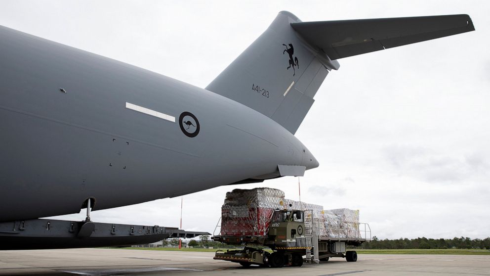 In this photo provided by the Australian Defence Force, a Royal Australian Air Force C-17A Globemaster III aircraft is loaded with aid at an airbase at Amberley, Australia, Thursday, Jan. 20, 2022. The first flights carrying fresh water and other aid