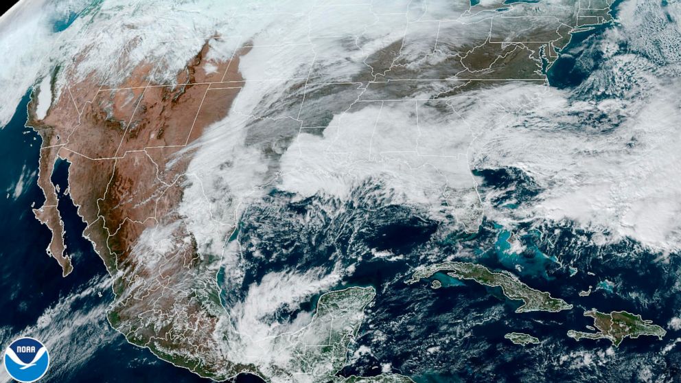 This satellite image made available by NOAA shows cloud cover over North America on Wednesday, Dec. 21, 2022 at 1:31 p.m. An arctic blast is bringing extreme cold, heavy snow and intense wind across much of the U.S. this week — just in time for the h