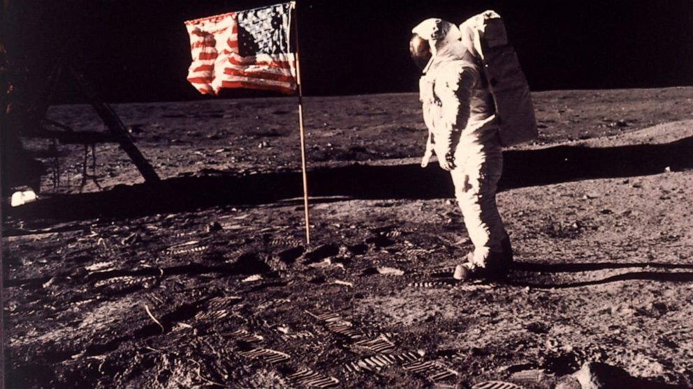 FILE - In this image provided by NASA, astronaut Buzz Aldrin poses for a photograph beside the U.S. flag deployed on the moon during the Apollo 11 mission on July 20, 1969. Television is marking the 50th anniversary of the July 20, 1969, moon landing
