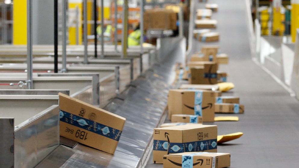 FILE - In this Dec. 17, 2019, file photo, Amazon packages move along a conveyor at an Amazon warehouse facility in Goodyear, Ariz. Amazon’s pandemic boom isn’t showing signs of slowing down. The company said Thursday, April 29, 2021, that its first-q