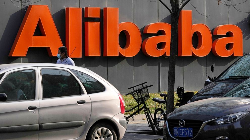 FILE - The Alibaba logo is seen outside a building in Beijing on Nov. 16, 2021. Chinese e-commerce giant Alibaba said in a statement Monday, Dec. 6, 2021, that it is replacing its CFO and restructuring its business as the company weathers a multiface
