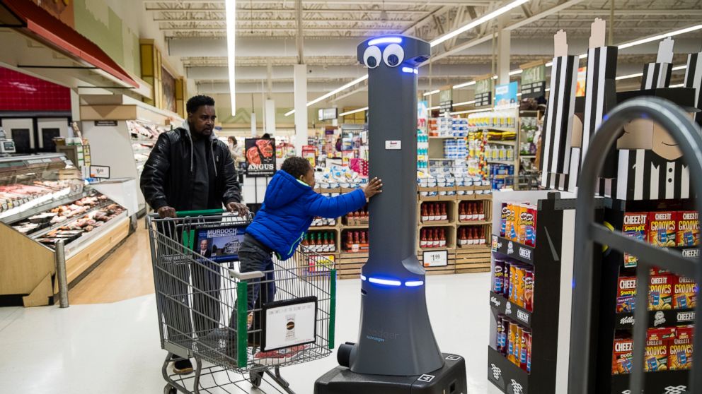 William Rucker and his grandson Justice, 4, say hello to a robot named Marty as it cleans the floors at a Giant grocery store in Harrisburg, Pa., Tuesday, Jan. 15, 2019. On Monday, the Carlisle-based Giant Food Stores announced new robotic assistants