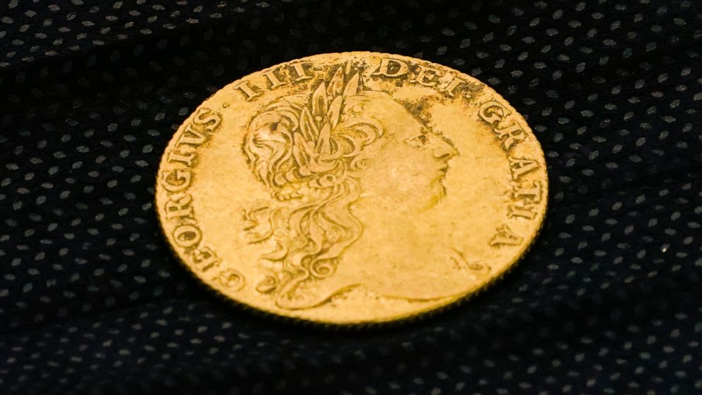 Shown is a King George III gold guinea, discovered in an excavation site at the Red Bank Battlefield Park in National Park, N.J., Tuesday, Aug. 2, 2022. Researchers believe they have uncovered in a mass grave in New Jersey the remains of as many as 1