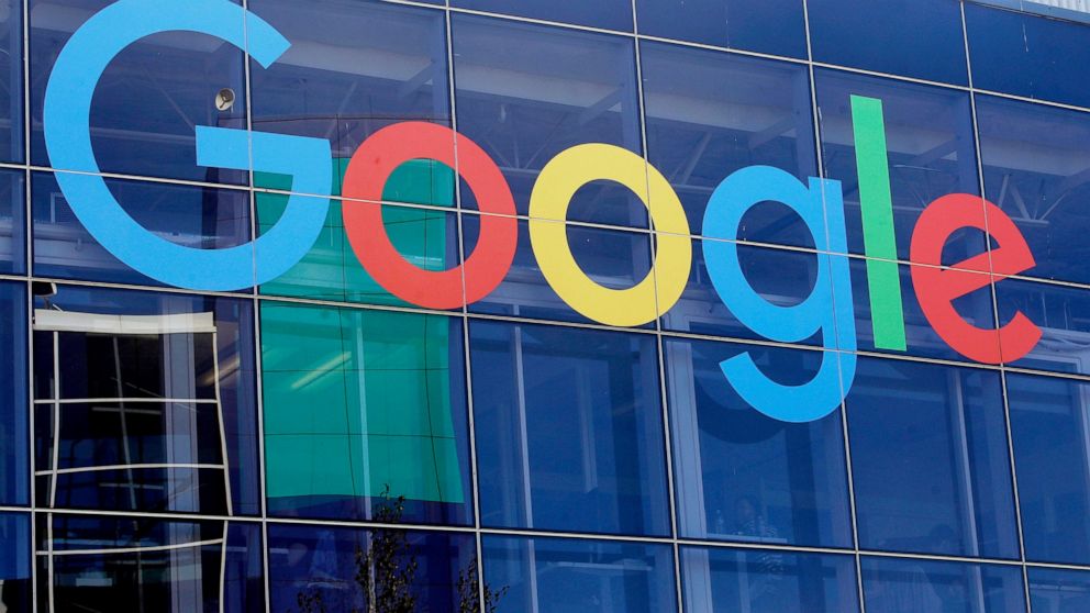 FILE - In this Sept. 24, 2019, file photo a sign is shown on a Google building at their campus in Mountain View, Calif. Google is once again postponing a return to the office for most workers until mid-January 2022. The internet search giant is also 