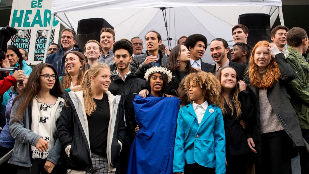 FILE - In this Oct. 29, 2018, file photo, young plaintiffs stand on the steps of the United States District Courthouse during a rally in Eugene, Ore., to support a high-profile climate change lawsuit against the federal government. A lawsuit by a gro