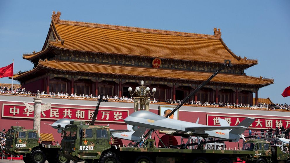 FILE - In this Thursday, Sept. 3, 2015 file photo, military vehicles carrying Wing Loong, a Chinese made medium-altitude long-endurance unmanned aerial vehicle, drive past Tiananmen Gate in Beijing. Serbia has praised China for boosting the Balkan na