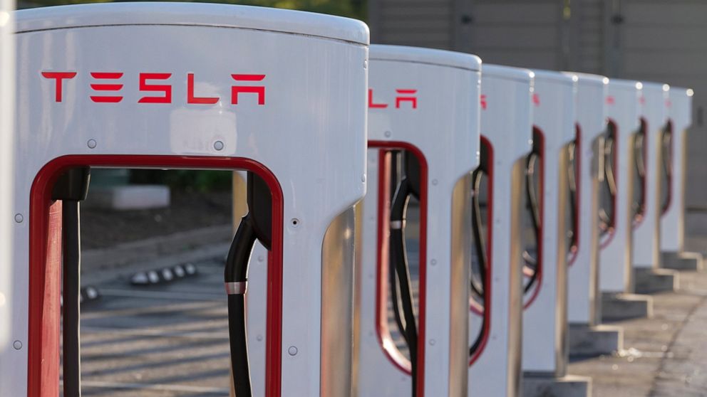 FILE -This April 22, 2021, photo shows a Tesla Supercharger station in Buford, Ga. Tesla proposed a three-for-one split of its stock on Friday, June 10, 2022, a move that will make a single share of the electric car maker more accessible to investors
