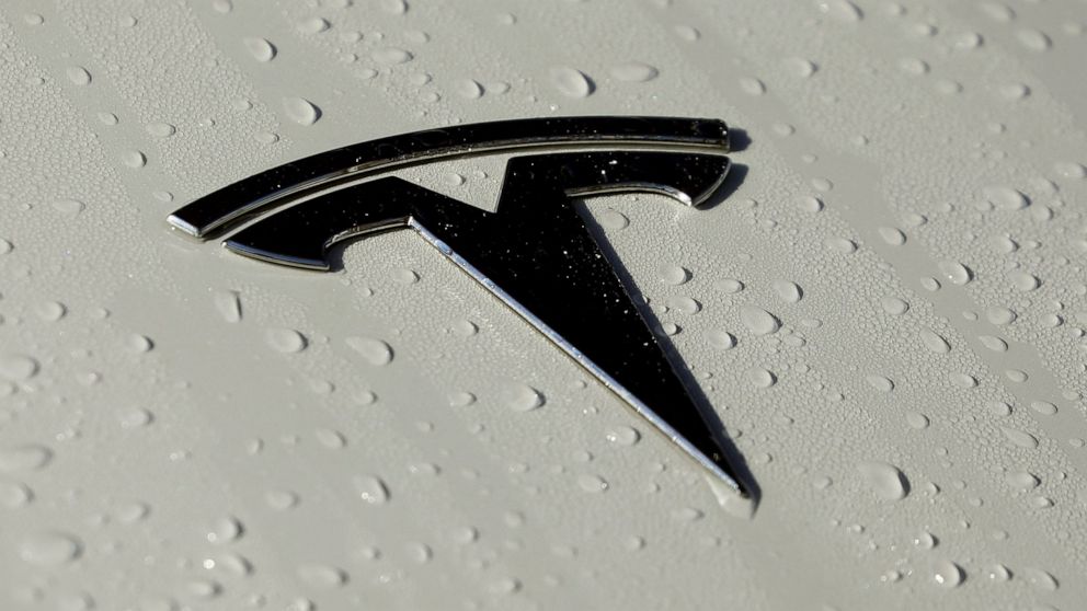FILE - This Oct. 18, 2019, photo shows a Tesla logo in Salt Lake City. The government plans soon to release data on collisions involving vehicles with autonomous or partially automated driving system that will likely single out Teslas for a dispropor