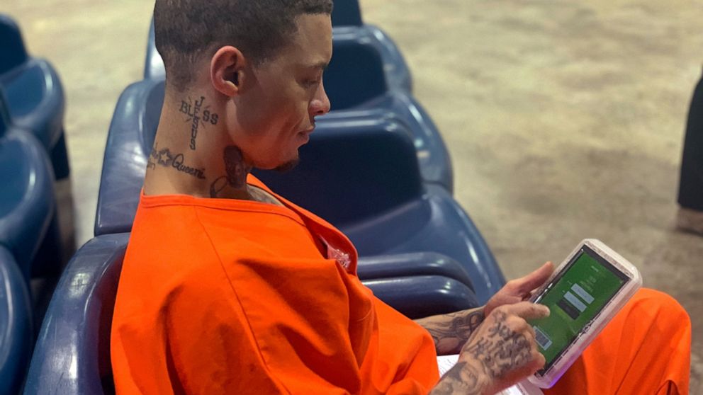 In a photo provided by the North Fork Correctional Center in Sayre, Oklahoma on Tuesday, June 9, 2021, inmate Byron Robinson works on a new Securus tablet, which are being provided for free to Oklahoma inmates as part of a new program by the Departme