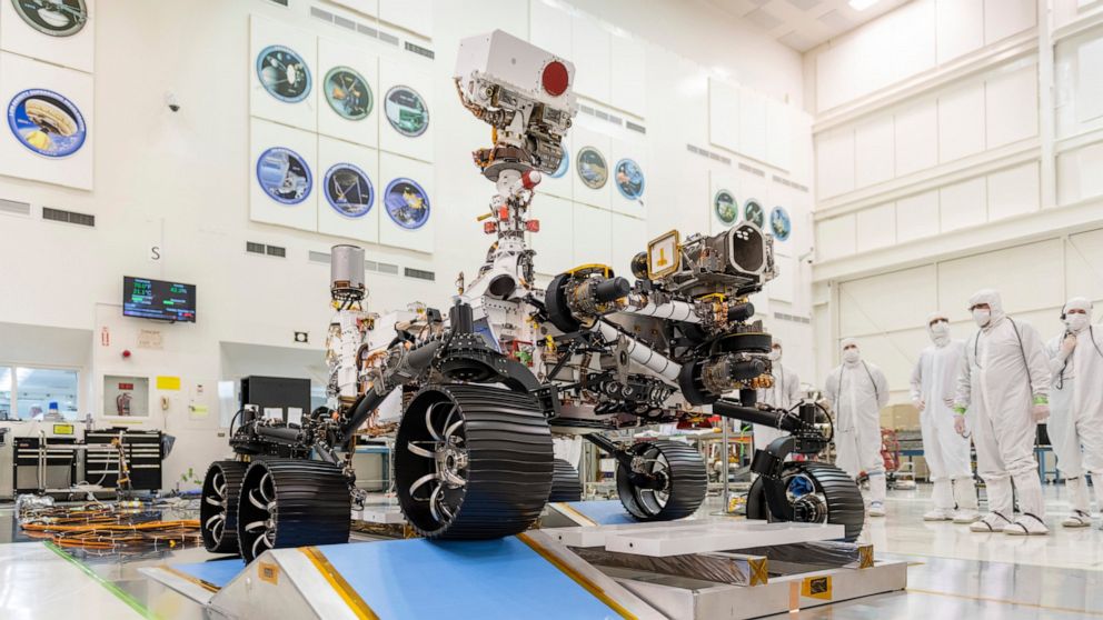 In this Dec. 17, 2019 photo made available by NASA, engineers watch the first driving test for the Mars 2020 rover in a clean room at the Jet Propulsion Laboratory in Pasadena, Calif. On Thursday, March 5, 2020, NASA announced the explorer's name wil