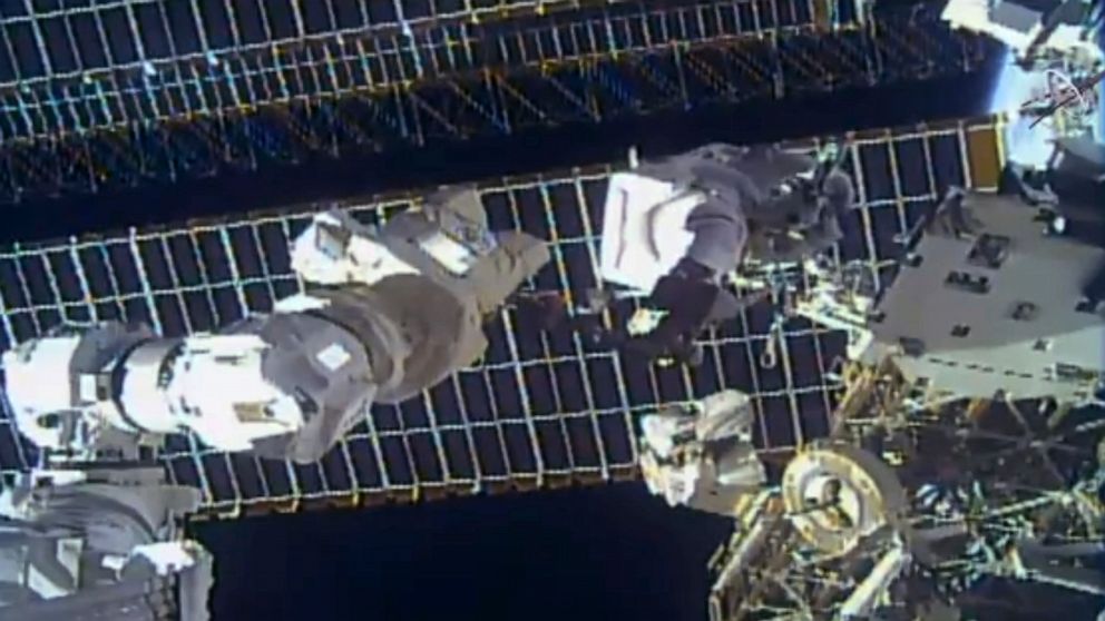 Spacewalking astronauts replace antenna after debris scare