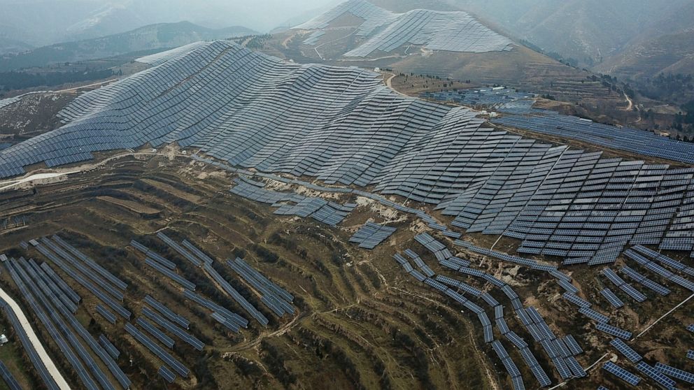 In this Nov. 27, 2019, photo, a solar panel installation is seen in Ruicheng County in central China's Shanxi Province. As world leaders gather in Madrid to discuss how to slow the warming of the planet, a spotlight is falling on China, the top emitt
