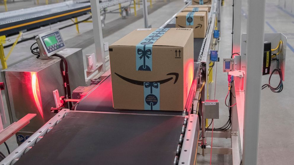 In this Dec. 5, 2018, photo a box is scanned and weighed before at the Amazon fulfillment center on Staten Island borough of New York. Amazon reports financial results Thursday, Jan. 31, 2019. (AP Photo/Mary Altaffer)